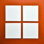 square white papers on orange surface